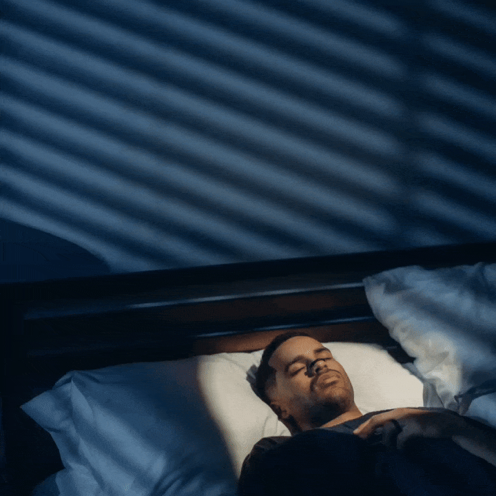 a man sleeping with a nasal dilator on