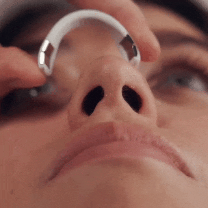a woman applying a magnetic nasal dilator