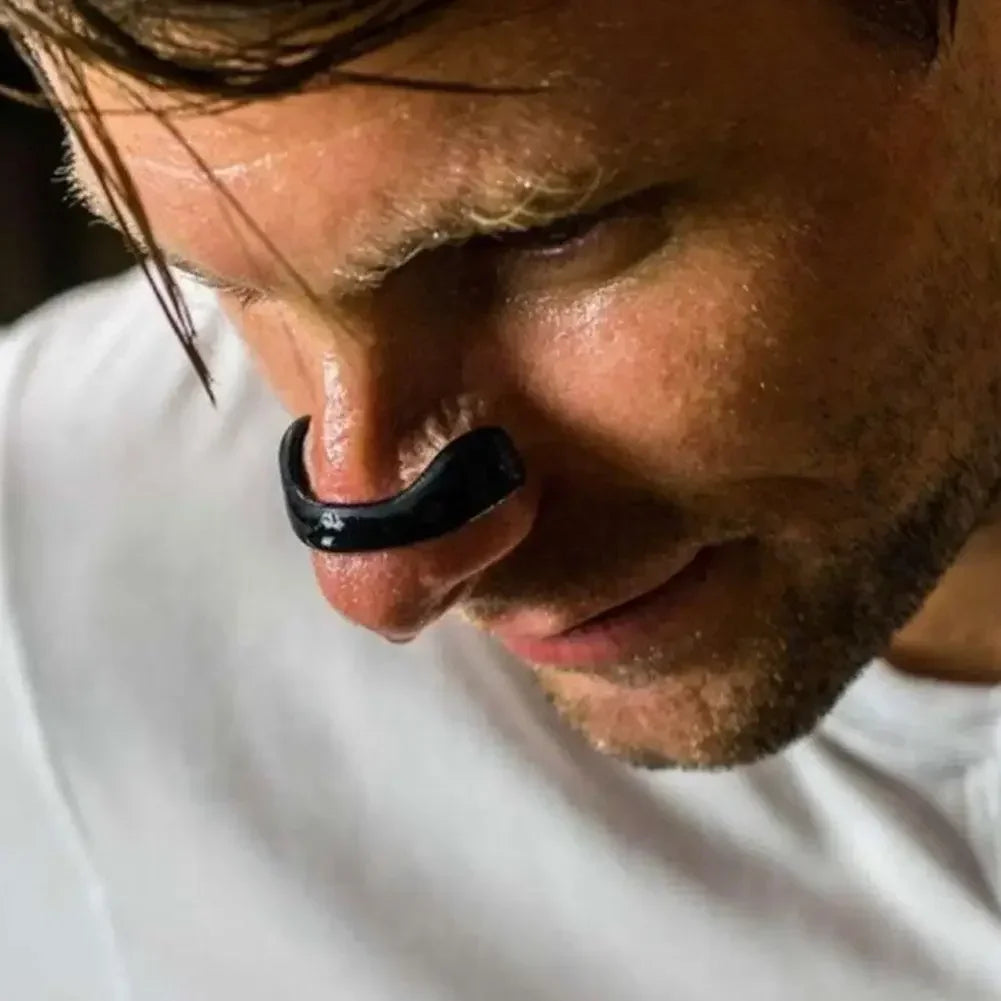 Close-up of a person wearing a black earring.
