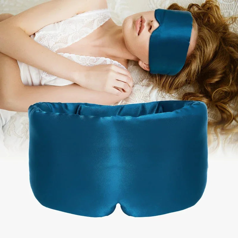 Person wearing a blue eye mask and using a blue pillow on a white background