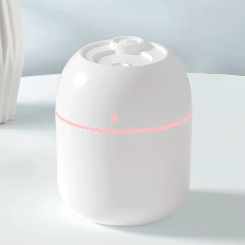 White humidifier with a red light on a light gray background